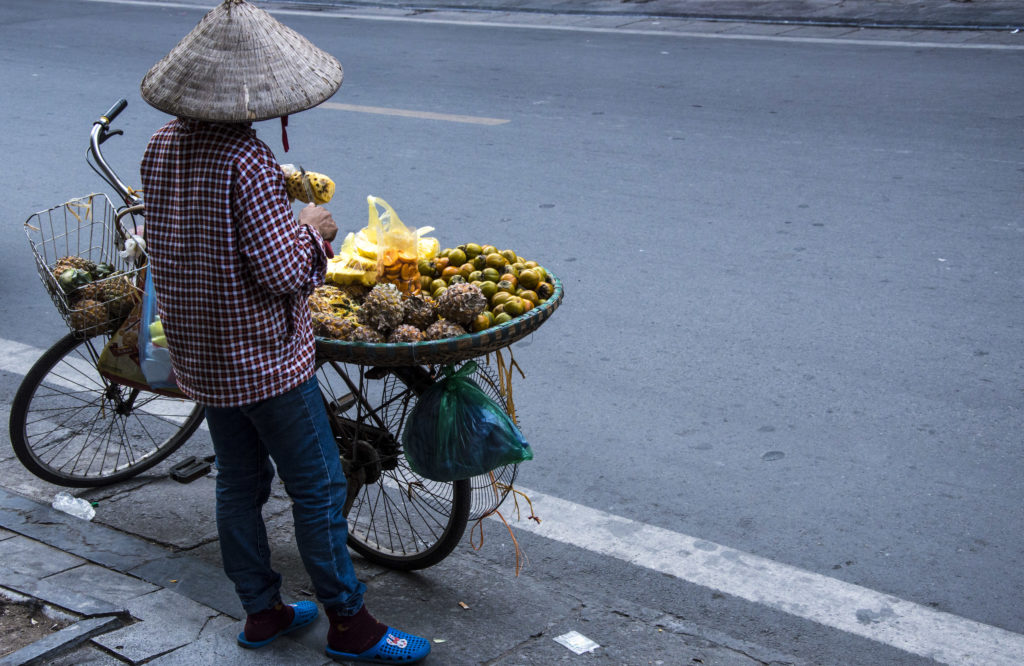 woman peeling pineapples