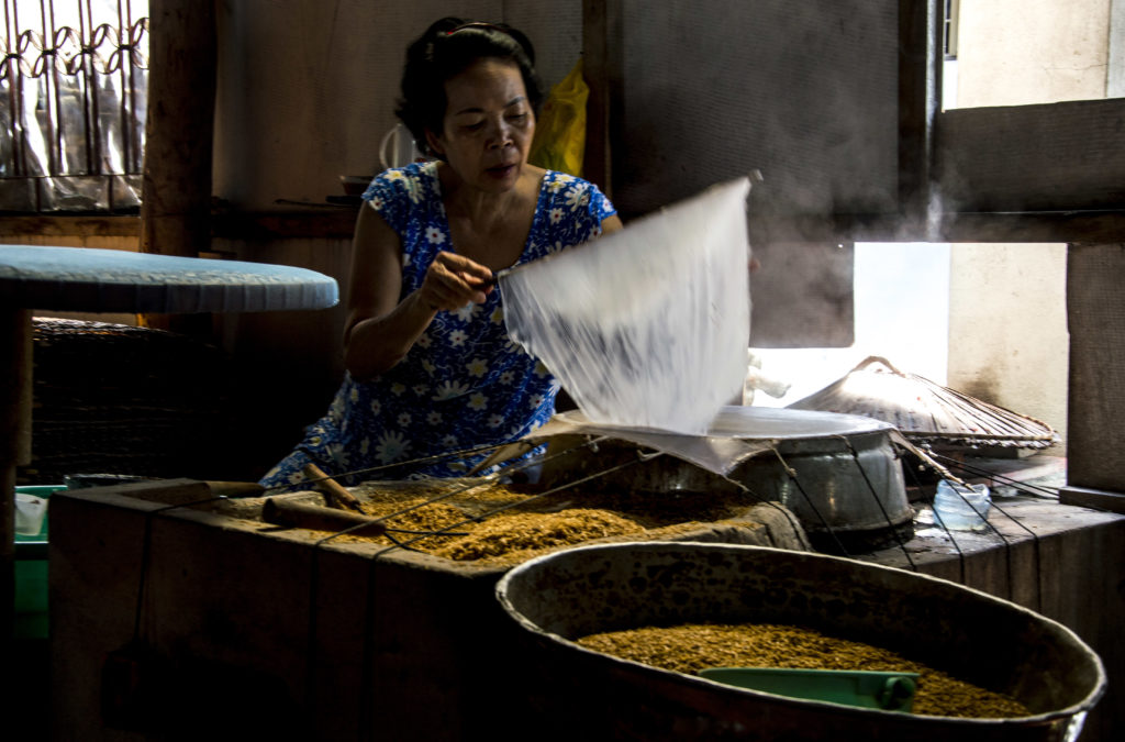 woman making rice paper