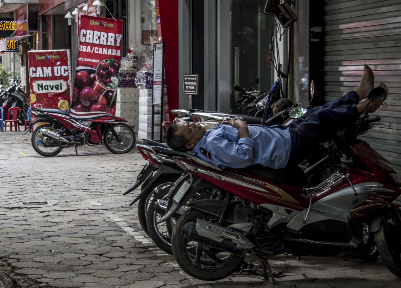 Policeman sleeping on motorbike